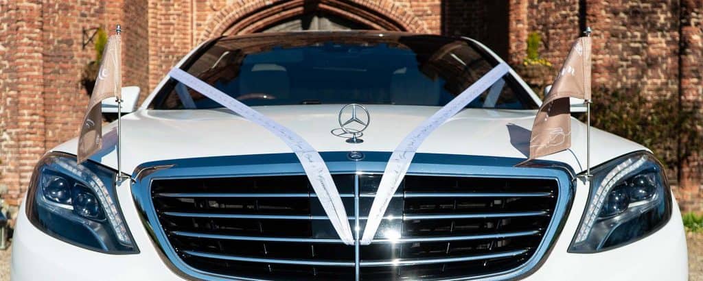 wedding car hire with ribbons and flags