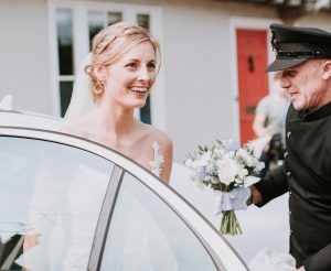 Chauffeur helping bride