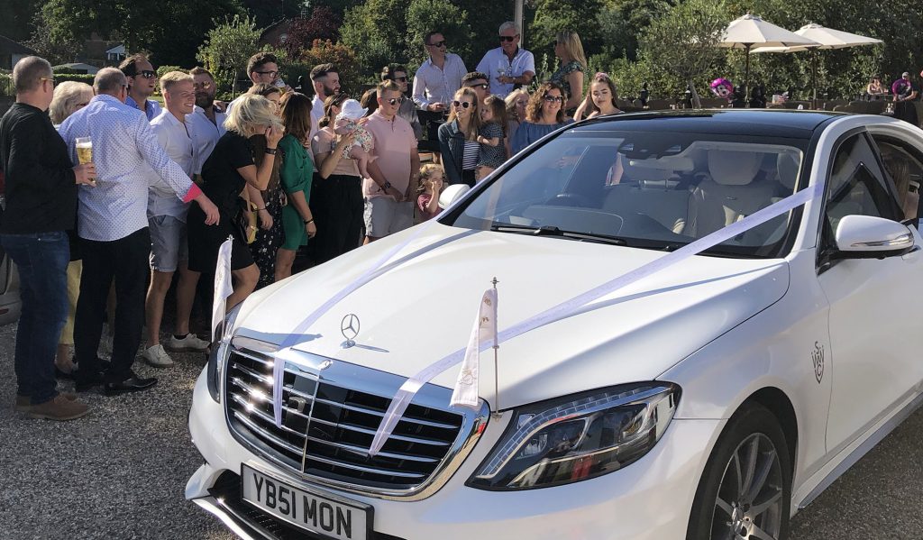 wedding car with guests